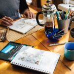 An artist surrounded by tools typically used in art challenges.