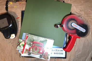 Recycled holiday cards, a 2 inch punch, an ATG 714 tape gun, a 12 by 12 piece of cardstock, and a 12 by 12 frame.