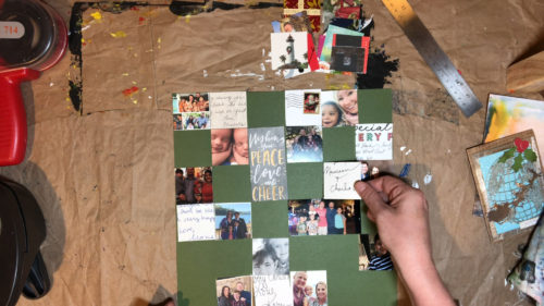 Arranging recycled holiday card squares on a piece of cardstock.