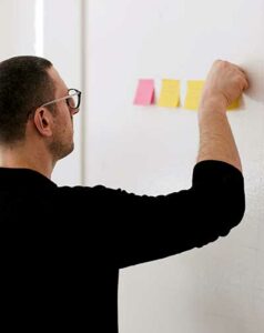 man with goal setting sticky notes